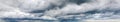 Stormy cloudy sky wide panorama, dramatic dark blue thunderclouds, gale cloudscape, gray cumulus rain clouds panoramic view Royalty Free Stock Photo