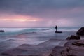 Stormy coast with a glimpse of sunrise through clouds