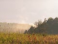 Stormy couds and sunset sky over fields