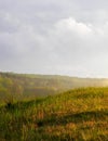 Stormy couds and sunset sky over fields