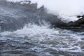 Stormy creek. wave and foam in the flow. splashes, bubbles, waves, stream, ripples and crests of waves in a fast forest stream in Royalty Free Stock Photo