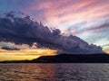 Stormy dark cumulonimbus cloud in a bright sunset sky