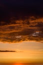 Stormy dramatic sky background with yellow red and orange clouds. Sunset skyline. Storm on the beach. Vertical size. Royalty Free Stock Photo