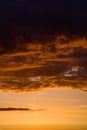 Stormy dramatic sky background with yellow red and orange clouds. Sunset skyline. Storm on the beach. Vertical size. Royalty Free Stock Photo