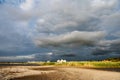 Stormy dramatic sky and sunny light at cosy marine in Germany