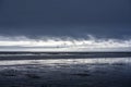 Stormy evening landscape coast of the Northwest Pacific Ocean with the remains of an old marina and flying albatrosses Royalty Free Stock Photo