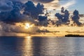 Stormy evening sky painted in stunning colors at sunset in the Indian ocean with silhouette of island and boat Royalty Free Stock Photo