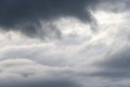 Stormy gray skies with some clouds highlighted white by the sun, as a nature background