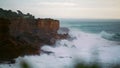 Stormy ocean breaking cliffs in slow motion. Powerful waves crashing wild rocky Royalty Free Stock Photo