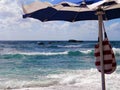 Stormy ocean in a sunny day & beach umbrella Royalty Free Stock Photo