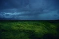 Green wheat field with stormy rainy dark clouds over the Western Plain of Romania. Royalty Free Stock Photo