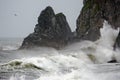 Stormy seascape. Waves and surf at the rocky Cape Uelen at the entrance to the Bering Strait