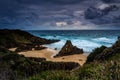 Stormy skies over coastal landscape with impressive sea stacks