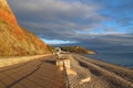 A stormy sky and evening sun on the esplanade at Seaton, in Devon on the Jurassic coast of Lyme Bay Royalty Free Stock Photo
