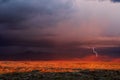 Stormy sky with lightning and dramatic sunset light in the desert Royalty Free Stock Photo
