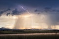Stormy sky with lightning and golden sunlight