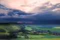 Stormy sky over bright countryside landscape