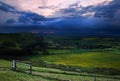 Stormy sky over bright countryside landscape