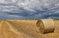 stormy sky over field with straw bale Royalty Free Stock Photo