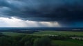 Stormy sky over a green field, rain