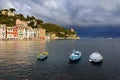 Stormy sky and small boats in sea bay of Portofino town. Portofino is small fishing town in Liguria district in Italy. Royalty Free Stock Photo