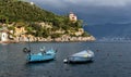 Stormy sky and small boats in sea bay of Portofino town. Portofino is small fishing town in Liguria district in Italy.