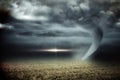 Stormy sky with tornado over field