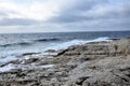 Stormy sky and waves crushing island coast Royalty Free Stock Photo