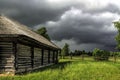 Stormy sky and wooden village house