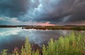 Stormy sunset sky over wild lake Royalty Free Stock Photo