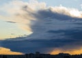 Stormy supercell weather over the city at sunset. Royalty Free Stock Photo