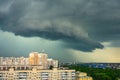 Stormy thunderclouds with heavy rain over multi-storey residential buildings in the city