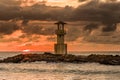 Stormy tropical sunset behind a small lighthouse (Khao Lak, Thailand