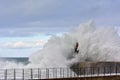 Stormy wave over old lighthouse and pier of Viavelez. Royalty Free Stock Photo