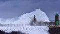 Stormy wave over old lighthouse and pier of Viavelez. Royalty Free Stock Photo