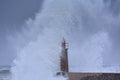 Stormy wave over old lighthouse and pier of Viavelez. Royalty Free Stock Photo