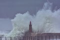 Stormy wave over old lighthouse and pier of Viavelez. Royalty Free Stock Photo