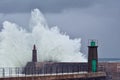 Stormy wave over old lighthouse and pier of Viavelez. Royalty Free Stock Photo