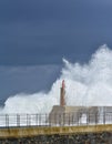 Stormy wave over old lighthouse and pier of Viavelez. Royalty Free Stock Photo