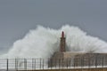 Stormy wave over old lighthouse and pier of Viavelez. Royalty Free Stock Photo