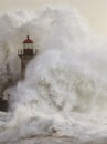 Stormy wave splash covering old lighthouse Royalty Free Stock Photo