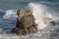 Splashing waves against rocks. Ligurian sea. Italy