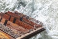 Stormy waves wash a wooden staircase. Top view. Rest and relaxation at the resort. Close-up