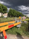 Stormy weather and dark clouds over a railway crossing in urban area. Uppsala, Sweden