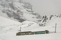 Train in Kleine Scheidegg under Eiger, Monch and Jungfrau peaks in Swiss Alps, Berner Oberland, Grindelwald,