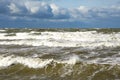 Stormy weather seascape, big waves with foam, low dark cumulus clouds, stormy sea view
