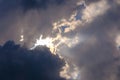 Stormy skies with sun rays breaking through white and dark clouds Royalty Free Stock Photo