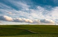 Stormy weather in the spring, clouds in the sky, green meadow, agriculture in Germany, landscape, wind energy and environment