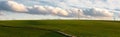 Stormy weather in the spring, clouds in the sky, green meadow, agriculture in Germany, landscape, wind energy and environment