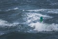 Green buoy in sea water